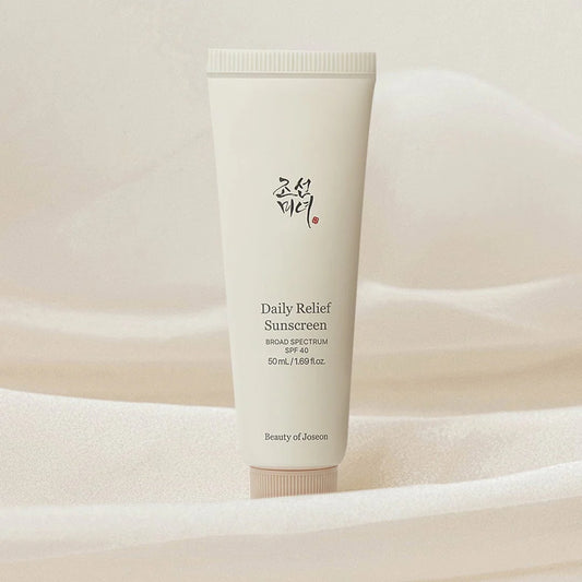 Tube of Daily Relief Sunscreen on a soft beige background
