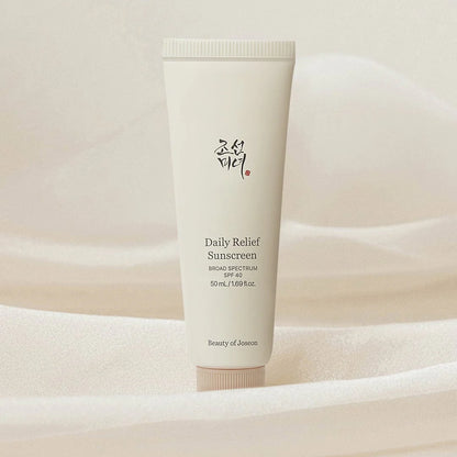 Tube of Daily Relief Sunscreen on a soft beige background