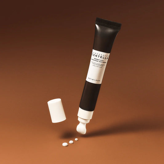 Skincare tube with white cap on a brown background